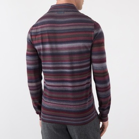 Model wearing Dolce & Gabbana blue striped wool polo, rear view, featuring multicolour horizontal stripes and long sleeves