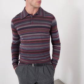 Model wearing Dolce & Gabbana blue striped wool polo shirt with collar and button placket, styled with grey trousers