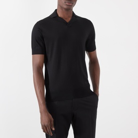 Model wearing Dolce & Gabbana black silk knit polo shirt with open collar and short sleeves, styled with black trousers