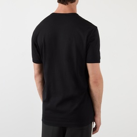 Model wearing Dolce & Gabbana Logo Badge T-Shirt in black, rear view, showing round neckline, short sleeves and straight hemline.