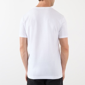 Model wearing Dolce & Gabbana Logo Badge T-Shirt in Optical White, rear view, round neckline, short sleeves, straight hemline.