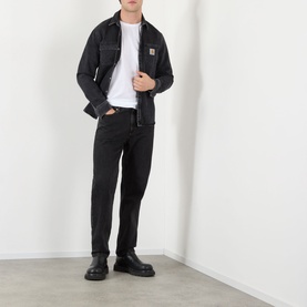 Model wearing Dolce & Gabbana Optical White Logo Badge T-Shirt, styled with black overshirt, black jeans and chunky boots.