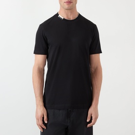 Model wearing Dolce & Gabbana Logo Tab T-Shirt in black with contrasting crew neck and logo tab detail, short sleeves, regular fit