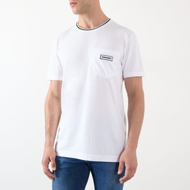 Model wearing Dolce & Gabbana Optical White Tipped Logo T-Shirt with navy tipped crew neck and chest logo badge, styled with blue jeans
