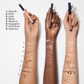 Est&eacute;e Lauder The Essential Eyeshadow Stick in Espresso, shown swatched across three skin tones alongside 8 shades from Oatmilk to Espresso