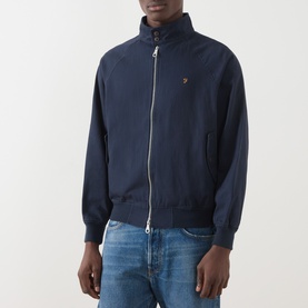 Model wearing Farah Vintage True Navy cotton casual jacket with full zip, funnel neck, and small logo embroidery, styled with blue jeans.