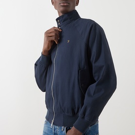Model wearing Farah Vintage True Navy casual jacket with zip front, ribbed cuffs and hem, small logo badge on chest.