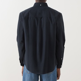 Model wearing Farah Vintage True Navy casual shirt, back view, long sleeves with button cuffs, paired with light blue jeans