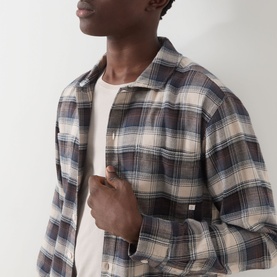 Model wearing Farah Vintage Dark Brown plaid flannel casual shirt, open collar, styled over a white crew-neck T-shirt