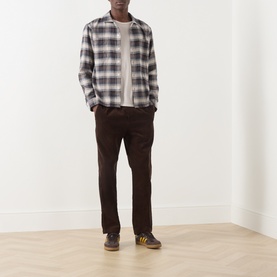 Model wearing Farah Vintage Dark Brown checked casual shirt, styled with dark brown trousers and yellow trainers.