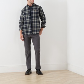 Model wearing Farah Vintage Rosemary check casual shirt in navy tones, styled with grey slim trousers and black leather shoes.