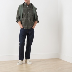 Model wearing Farah Vintage Rosemary green check casual shirt, styled with navy trousers and white trainers