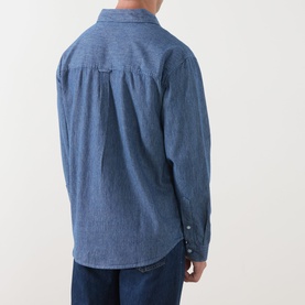 Model wearing Farah Vintage Casual Shirt in Mid Indigo, back view, 100% cotton chambray fabric, button cuffs, styled with indigo jeans.