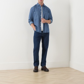 Model wearing Farah Vintage Mid Indigo casual shirt in 100% cotton, styled with dark indigo jeans and brown boots