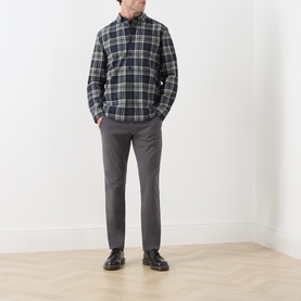 Model wearing Farah Vintage Charcoal Chinos with a dark plaid shirt and black leather shoes.