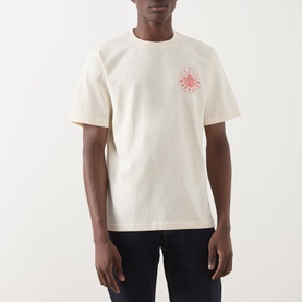 Model wearing Farah Vintage Ecru Crew Neck T-shirt with red circular chest graphic, styled with dark navy jeans.