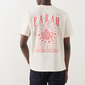 Model wearing Farah Vintage Ecru Crew Neck T-shirt, back view showing red Vintage Workwear graphic print, styled with dark jeans.