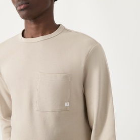Model wearing Farah Vintage Putty Crew Neck T-shirt in 100% cotton with chest patch pocket, cropped close-up view.