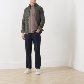 Model wearing Farah Vintage Dark Brown Crew Neck T-Shirt, styled with green check overshirt, navy jeans and white trainers.