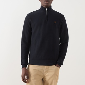 Model wearing Farah Vintage Navy Half Zip sweatshirt in cotton, featuring quarter zip collar and logo embroidery, styled with beige chinos.