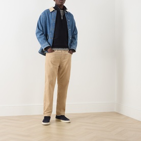 Model wearing Farah Vintage Navy Half Zip under a denim jacket, styled with tan chinos and navy slip-on shoes.
