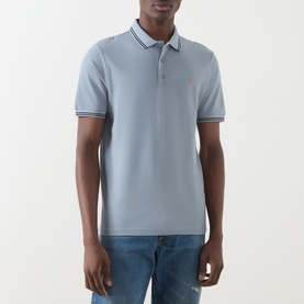 Model wearing Farah Vintage Polo in Icelandic Blue, piqu&eacute; cotton with contrast tipped collar and cuffs, small logo embroidery
