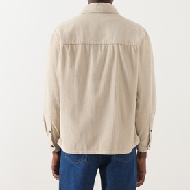 Model wearing Farah Vintage Putty Zip Through casual shirt, back view, styled with blue jeans. 100% cotton corduroy texture.