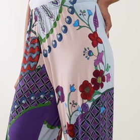 Model wearing Mey PJ Pants in Mystic Jade, featuring bold floral and geometric multicolour print on modal fabric, elasticated waist visible.