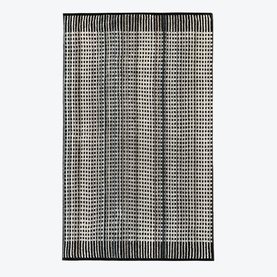 Odyssey Carnival Towel Black, 100% cotton beach towel with black and white geometric jacquard stripe pattern and fringe ends.
