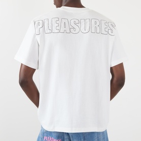 Model wearing Pleasures Impact Logo Graphic T-Shirt in white, rear view showing outlined PLEASURES back graphic, short sleeves, straight hem.