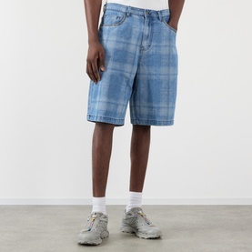 Model wearing Pleasures blue checked denim shorts, styled with white socks and grey chunky trainers.