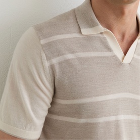 Model wearing Reiss beige stripe knit polo shirt with open collar, short sleeves, and tonal stripe detail