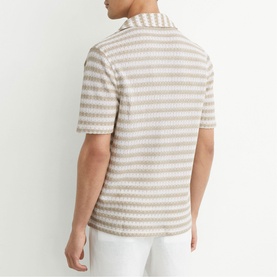 Model wearing Reiss white textured stripe short sleeve polo shirt, styled with white trousers, back view
