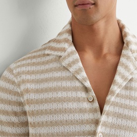 Model wearing Reiss white striped open-knit shirt with notch collar and button placket, close-up detail shot