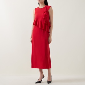 Model wearing Akris Punto red sleeveless midi dress with asymmetric ruffle detail, styled with black heels.