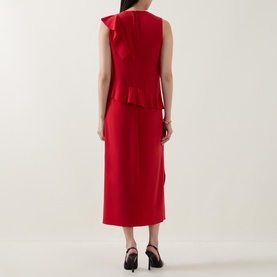 Model wearing Akris Punto red sleeveless midi dress with ruffle detail, shown from back, styled with black heeled sandals