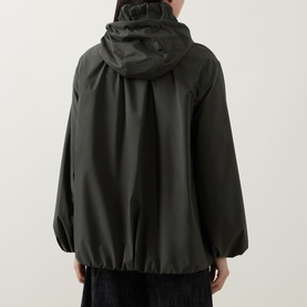 Model wearing Akris Punto olive parka, rear view showing hood, elasticated hem and blouson sleeves