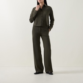 Model wearing Akris Punto olive shirt with matching wide-leg trousers and black loafers