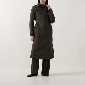 Model wearing Akris Punto Olive Trench Coat, double-breasted, belted, midi length, styled with wide-leg trousers and black flat shoes