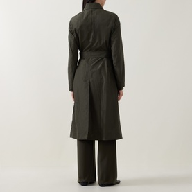 Model wearing Akris Punto olive trench coat, back view, with wide-leg trousers. Belted waist, midi length.