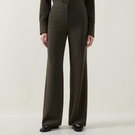 Model wearing Akris Punto olive wide-leg trousers, styled with a matching olive blazer and black shoes.