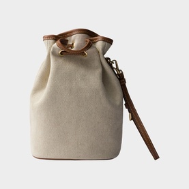 Prada Accessories neutral canvas bucket bag with tan leather trim, gold-tone hardware, drawstring top, and detachable wrist strap