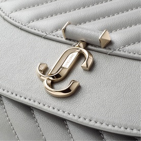Jimmy Choo bag in dove grey quilted leather with shiny gold JC logo clasp hardware and pyramid stud detail.