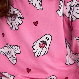 Model wearing Chelsea Peers Sleepover Ghost nightwear in bright pink with all-over ghost and red heart print, close-up detail shot