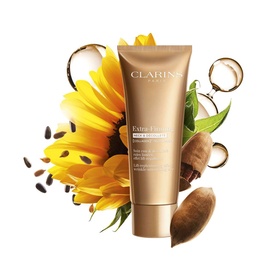 Clarins Extra-Firming Day Cream in gold tube, surrounded by sunflower, coconut, and botanical ingredients