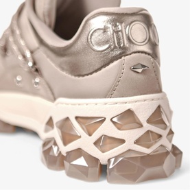 Jimmy Choo taupe metallic leather trainer, close-up of logo heel tab and geometric crystal-embellished chunky sole