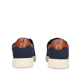 Cole Haan men's blue canvas trainers, tan leather heel counter with logo, cream rubber sole, rear view