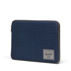 Herschel Laptop Case in Grid Naval Academy, navy blue grid fabric with grey zip trim and logo patch, angled view