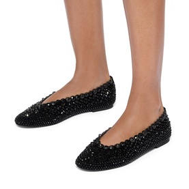 Model wearing black crystal-embellished ballet flats with scalloped edge trim and all-over rhinestone detailing, flat sole
