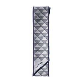 Prada silk scarf in grey and navy geometric triangle print with navy border, folded flat to show full length.